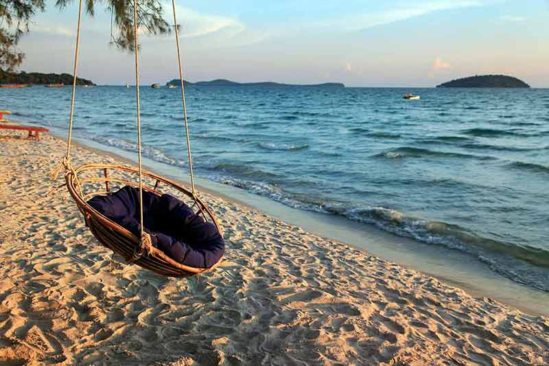 cambodia top beaches round rattan swing hanging from a tree above the sand