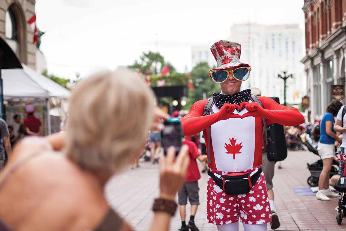 canada in summer weather man dressed in canadian flag costume