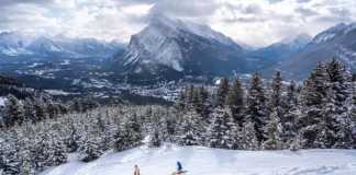 skiers in the rockies in canada in winter