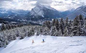 skiers in the rockies in canada in winter