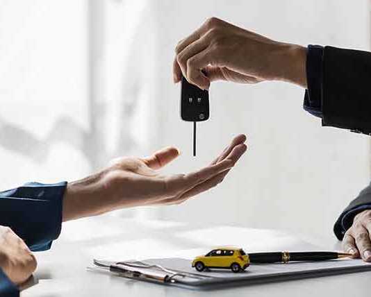 handing over the key to a rental car