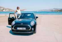 woman in a rental car on a beach in Mykonos