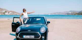 woman in a rental car on a beach in Mykonos