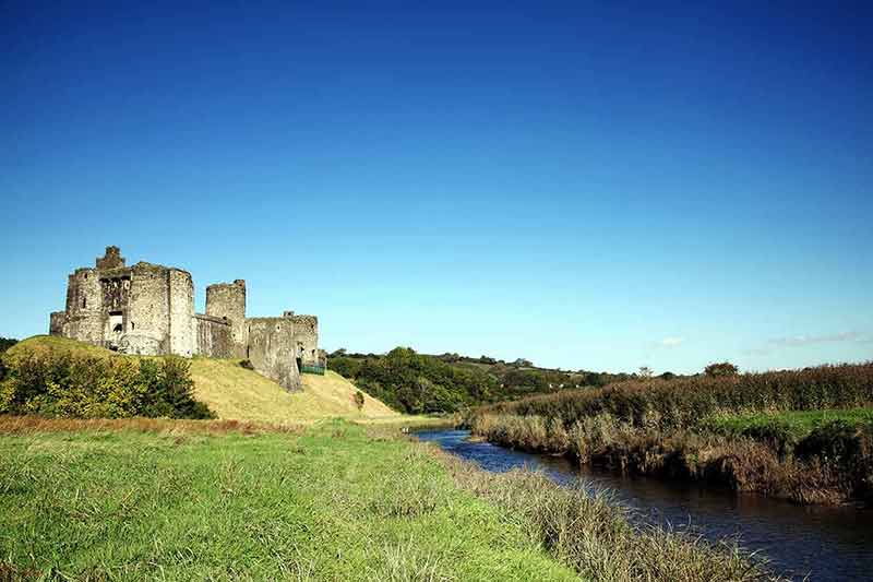 castles in wales for Kidwelly Castle, brook and green lawns