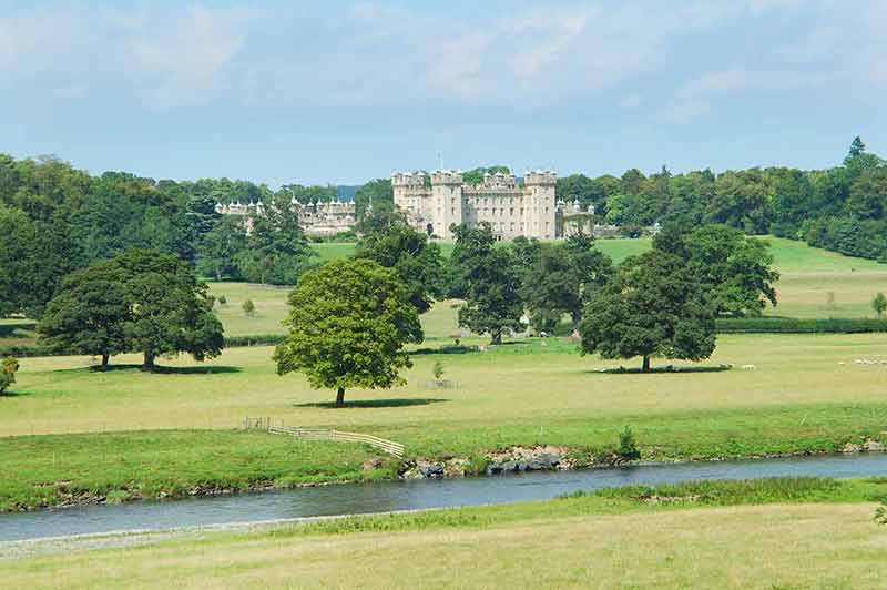 castles to stay in scotland Floors Castle and river Tweed