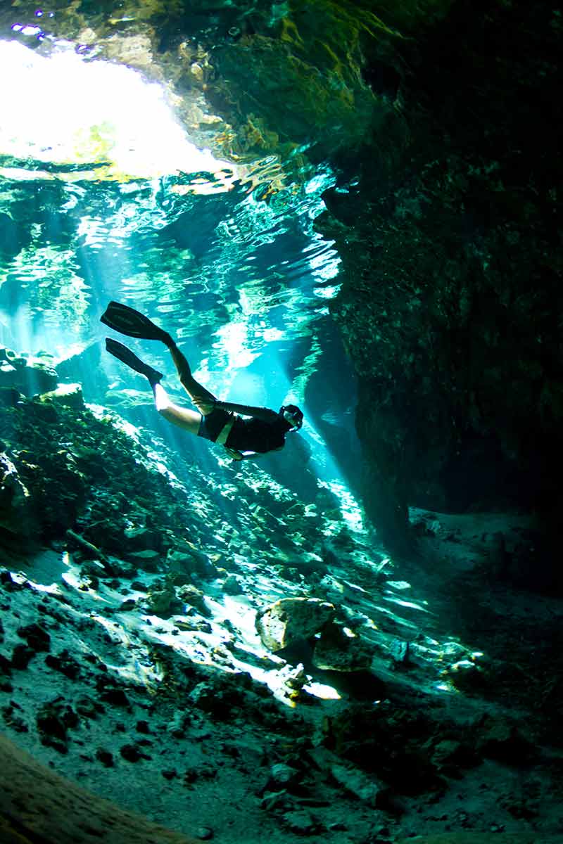 cenotes in mexico snorkeler wearing mask and fins