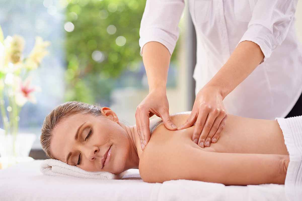 A Woman In A Day Spa Relaxing On A Massage