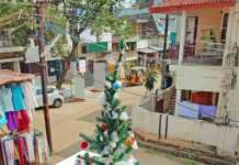 Christmas in India: What the Festive Season Is Really Like woman in red yoga outfit and santa hat meditating on a beach in Kerala during christmas in india