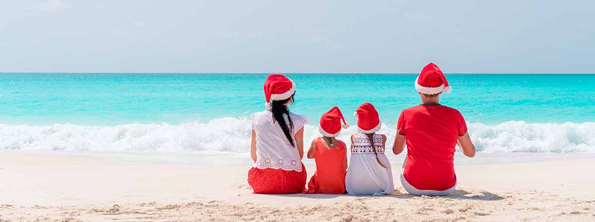 Happy Family On The Caribbean Beach Celebrating Christmas Vacation