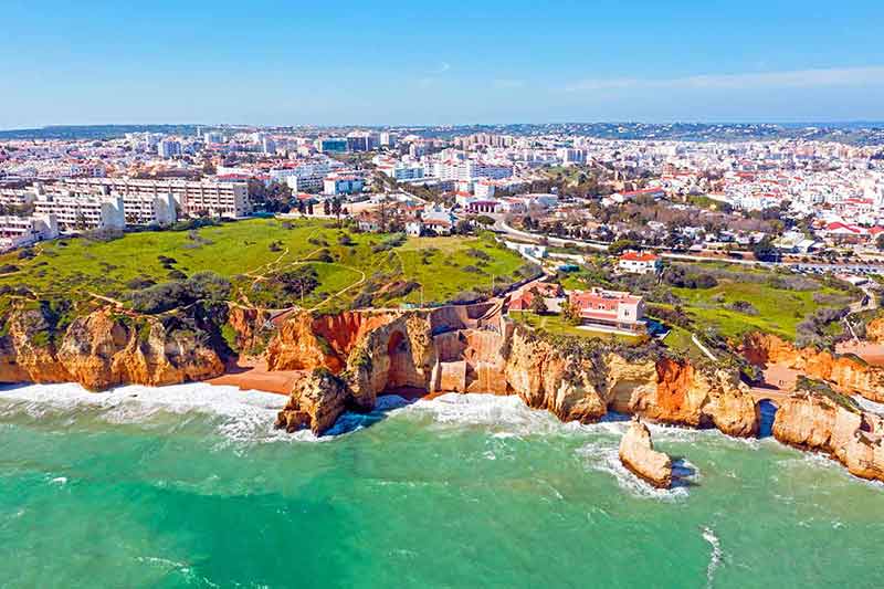 city Lagos in the Algarve Portugal aerial view of cliffs and city in the background