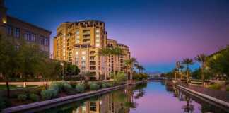 20 Arizona Cities And Towns Beyond The Grand Canyon buildings reflected in the canal in Scottsdale at dusk