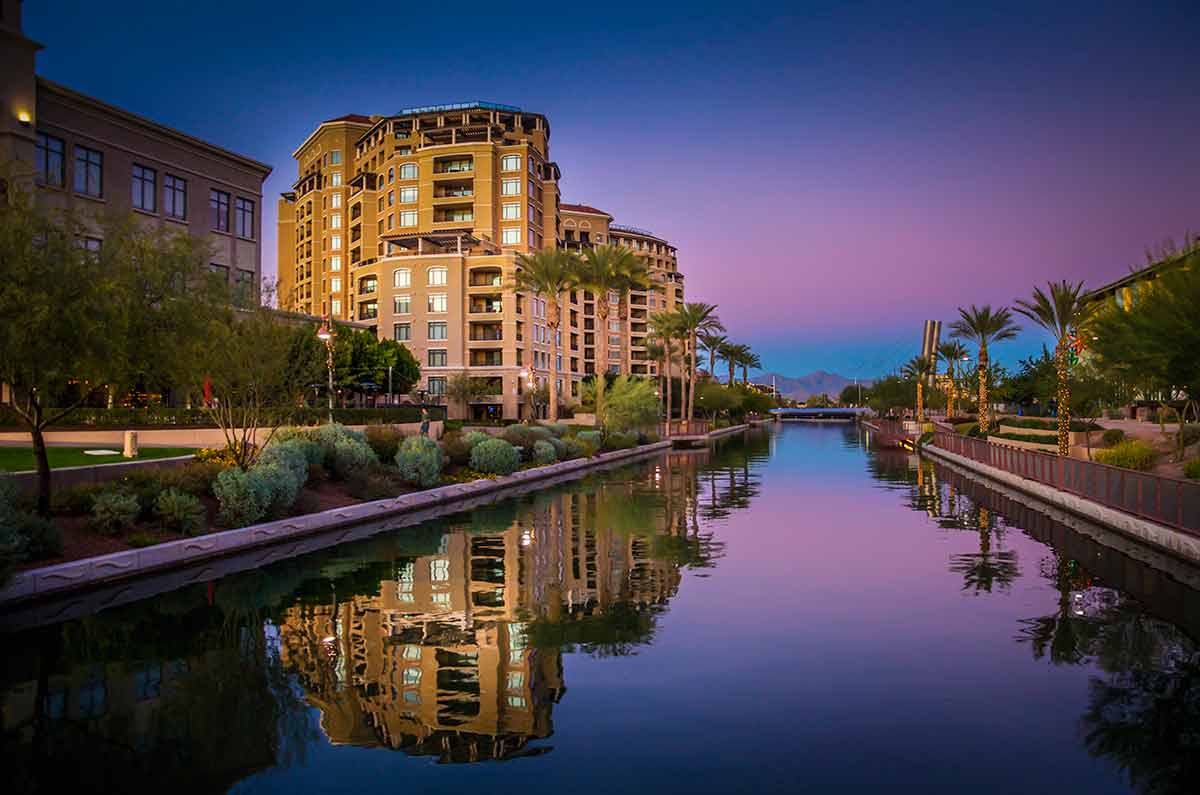 buildings reflected in the canal in Scottsdale at dusk