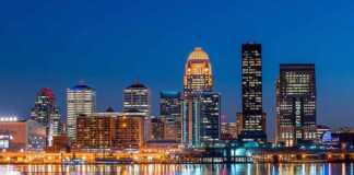 Louisville city skyline at night reflected in the water