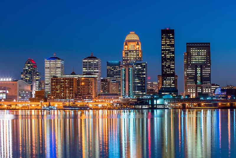 Louisville city skyline at night reflected in the water