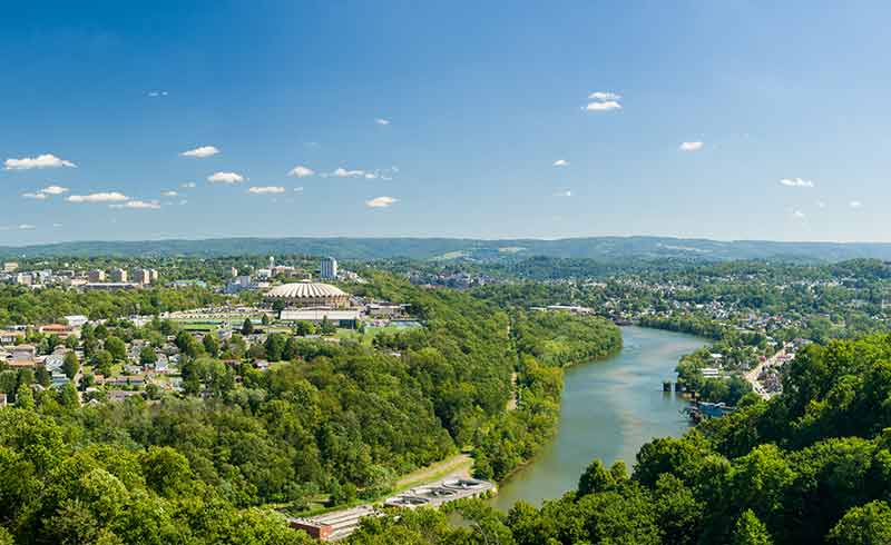 cities aerial view of morgantown, river and green belt