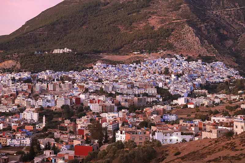 Chefchaouen City from a distance with mountain in the background