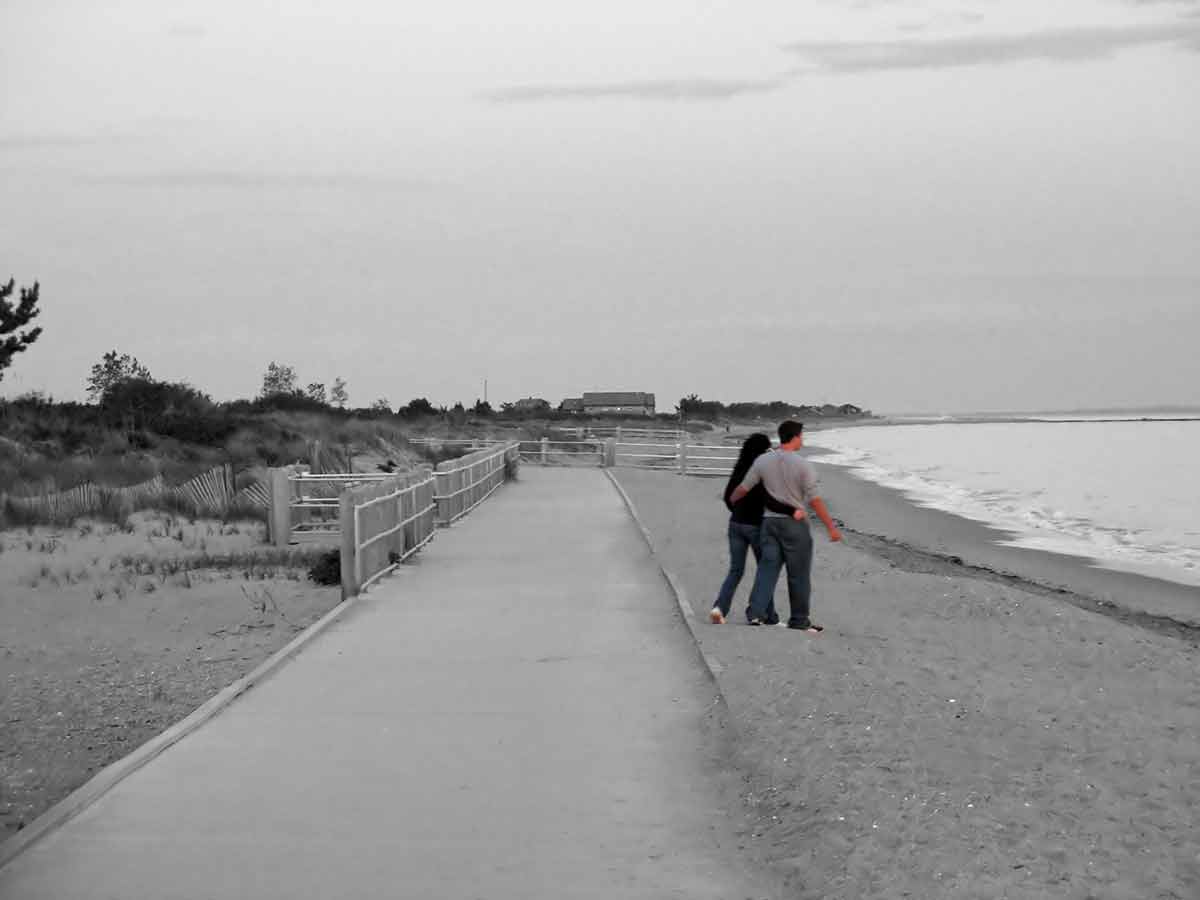 connecticut beaches A young couple walking on the beach