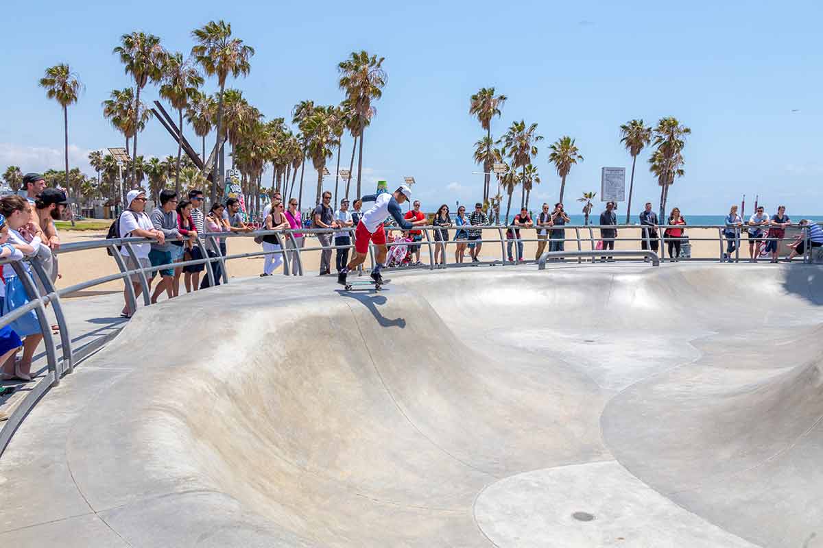 cool things to do in venice beach a skater performs for the crowd