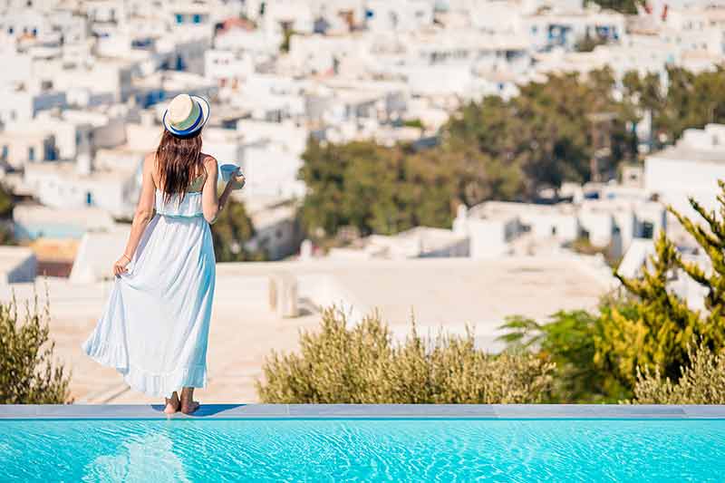 Woman relaxing by the pool in a luxury hotel resort