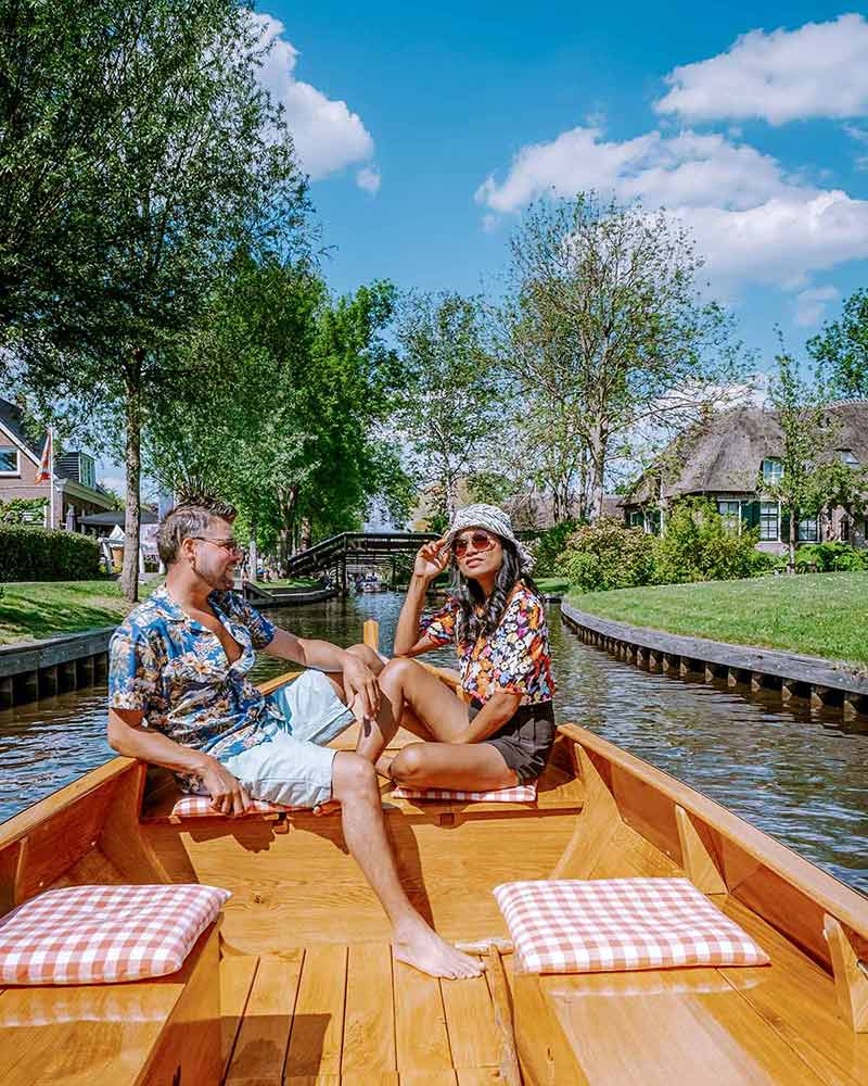 man and woman on a boat in a canal