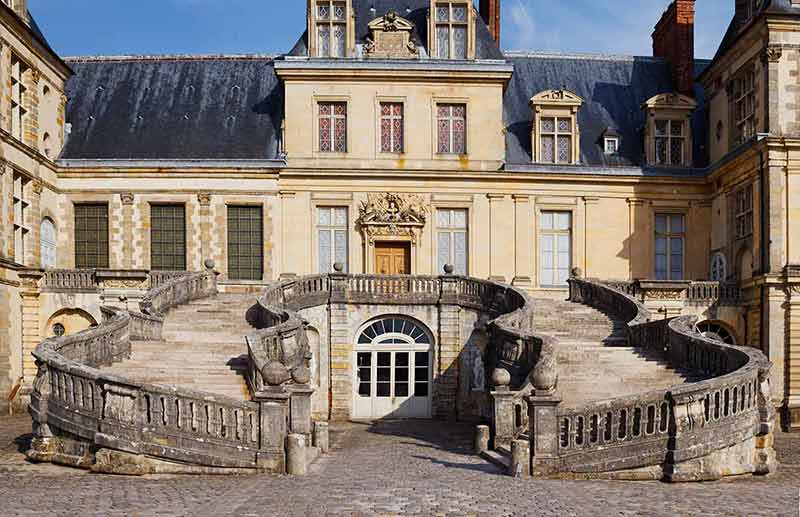 day trips paris Principal staircase Chateau de Fontainebleau, residence of Napoleon I, Paris.