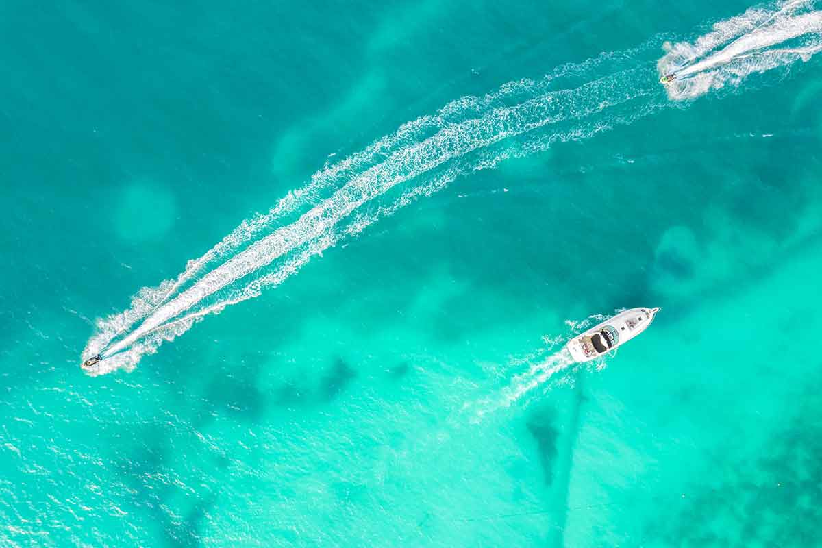 day trips cancun aerial view of speed boats in the Caribbean Sea