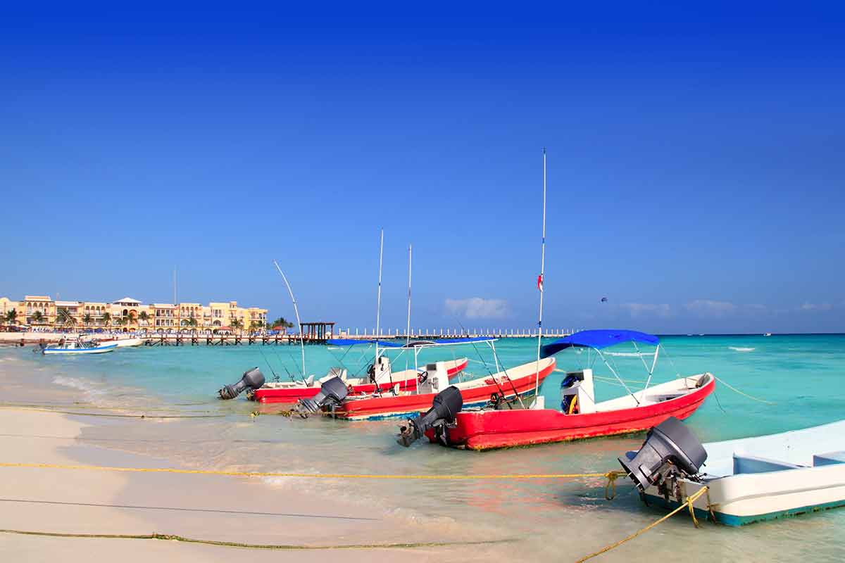 day trips to tulum from playa del carmen red boats moored at the beach