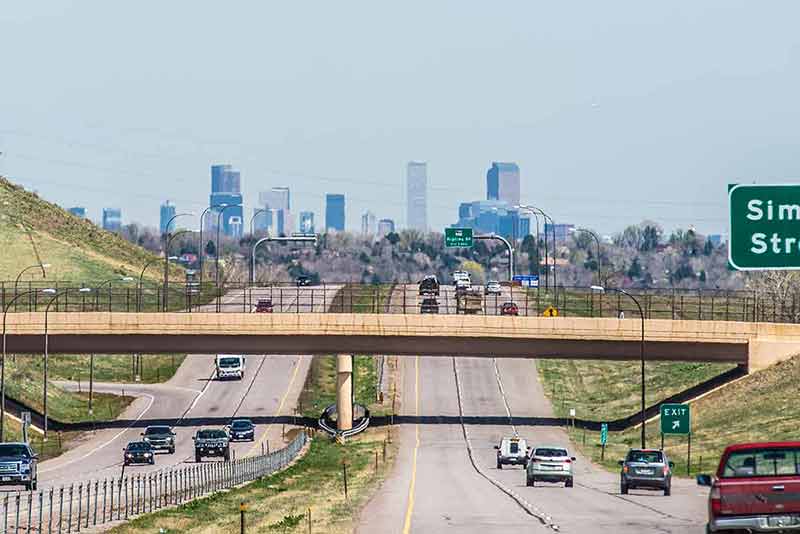 roads in and out of Denver with skyline in the distance