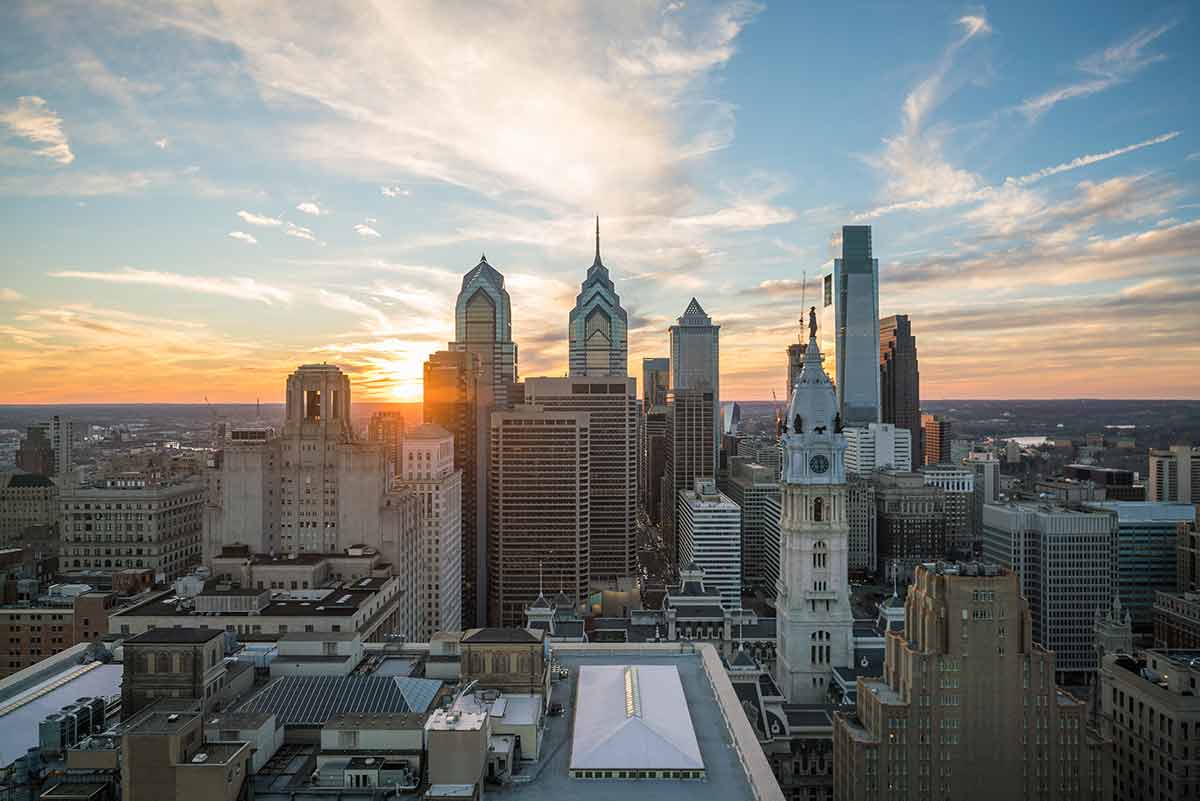 downtown philadelphia at night skyscrapers with sun behind them