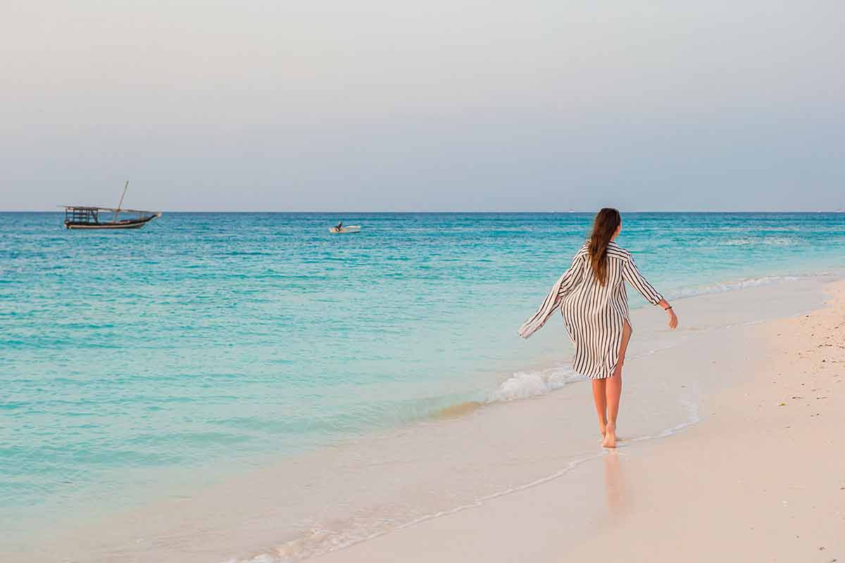 Woman Laying On The Beach Enjoying Summer Holidays