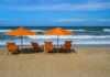 20 Best Things To Do In Duck NC On The Outer Banks orange beach chairs and umbrellas on a beach in duck north carolina
