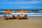 20 Best Things To Do In Duck NC On The Outer Banks orange beach chairs and umbrellas on a beach in duck north carolina