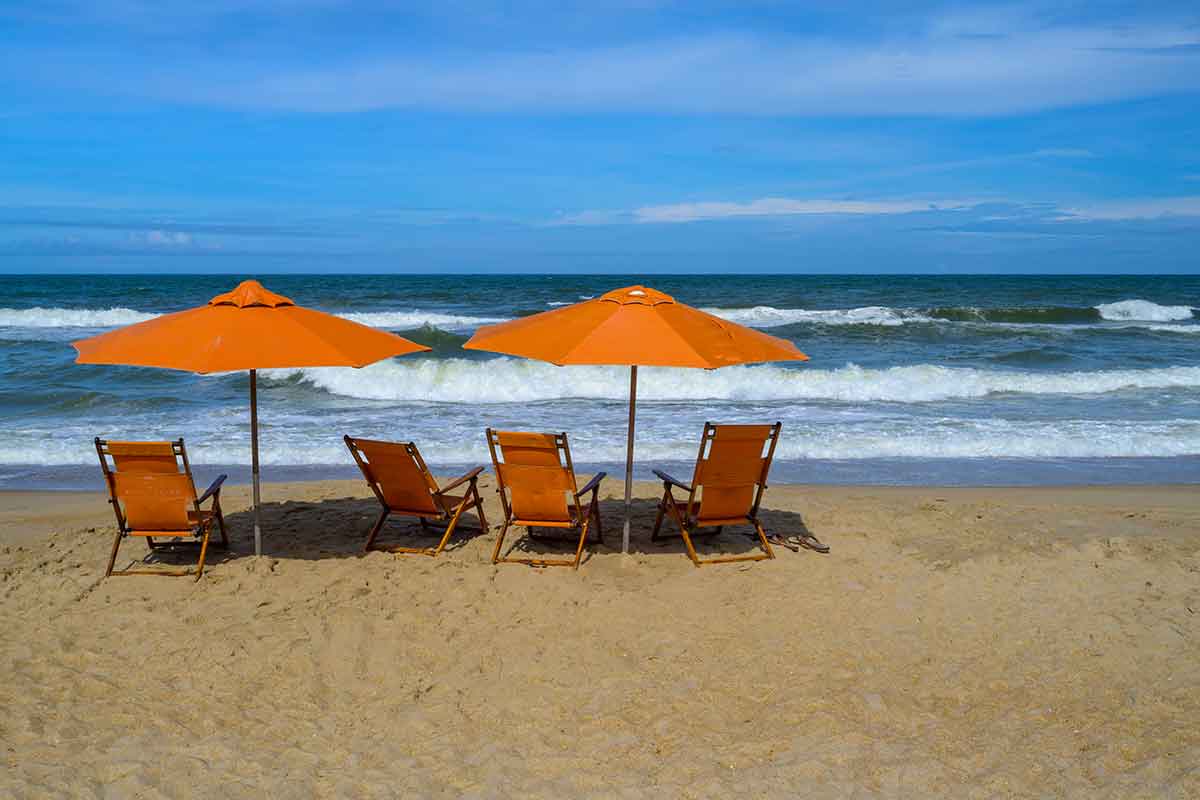orange beach chairs and umbrellas on a beach in duck north carolina