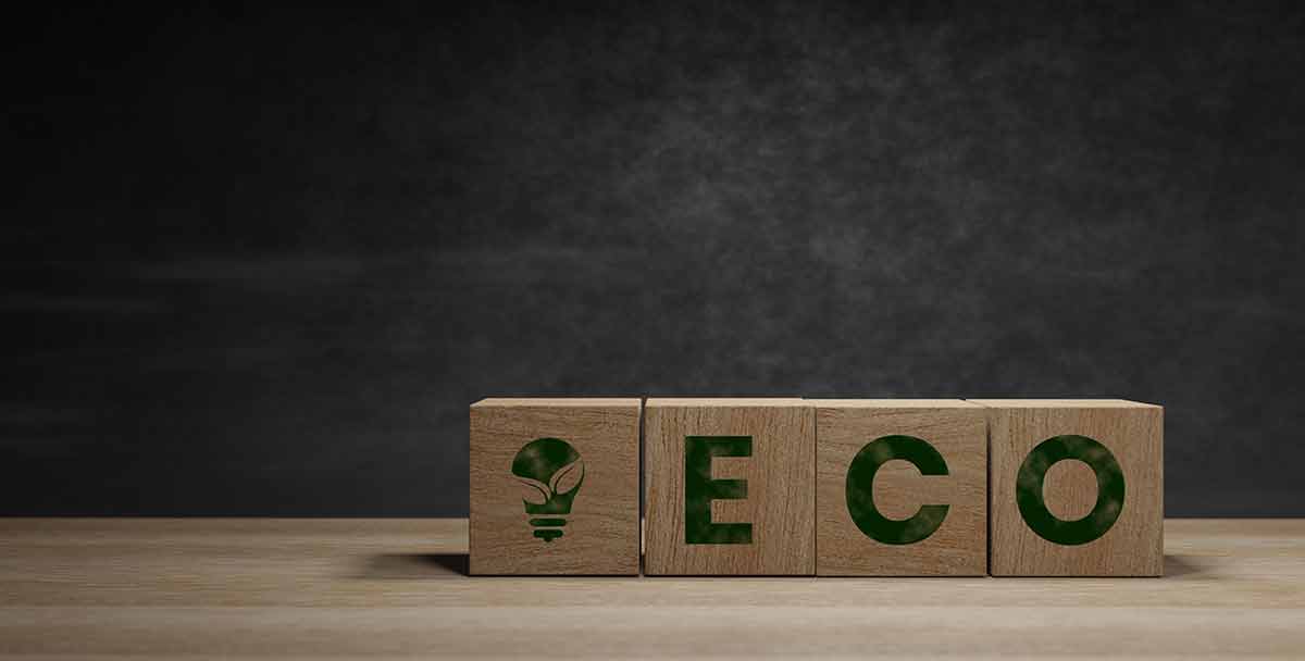 ecolodgeECO written on wooden blocks, environmental,Creative concept, Connecting with nature and social good in a dark background.