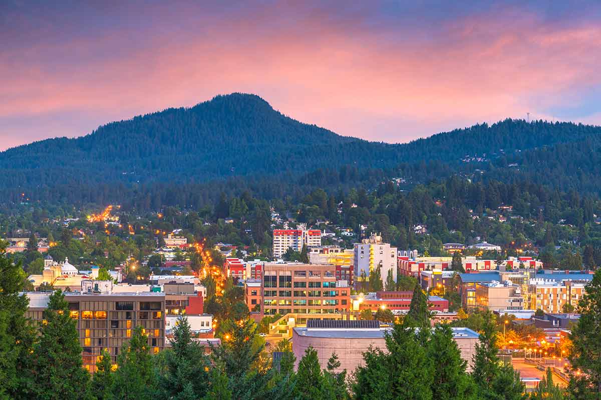 distant view of eugene at sunset with mountain backdrop