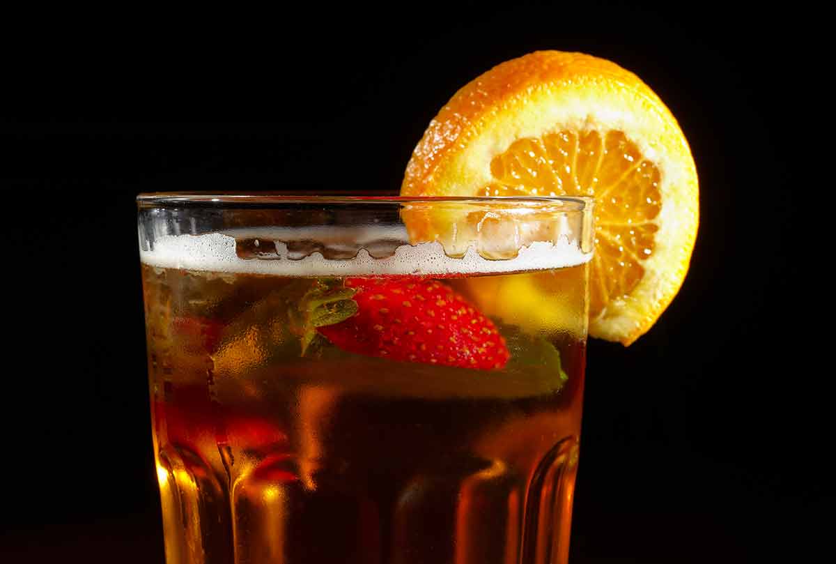 famous british drinks cocktail Pimm's Cup on a black background