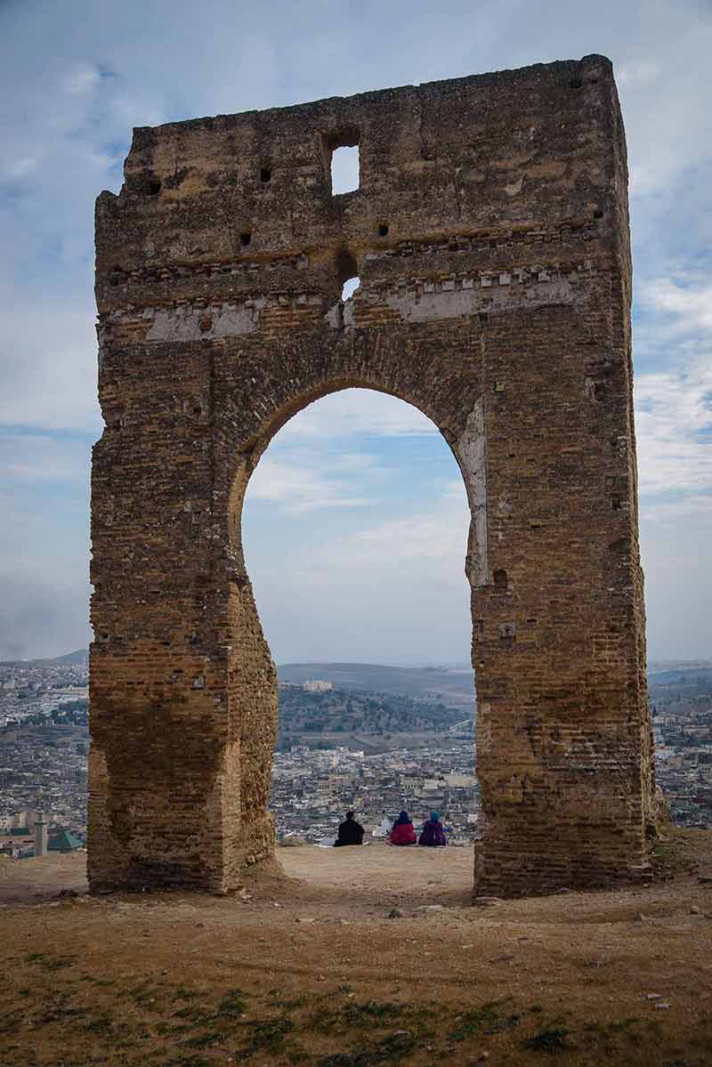 A family enjoying the evening in ancient Marinid Tombs on the hill in Fez. Morocco.