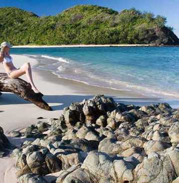 fiji beaches girl in a bikini sitting on a beach