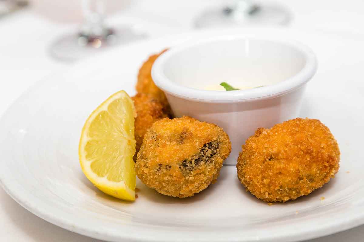 conch fritters with a slice of lemon