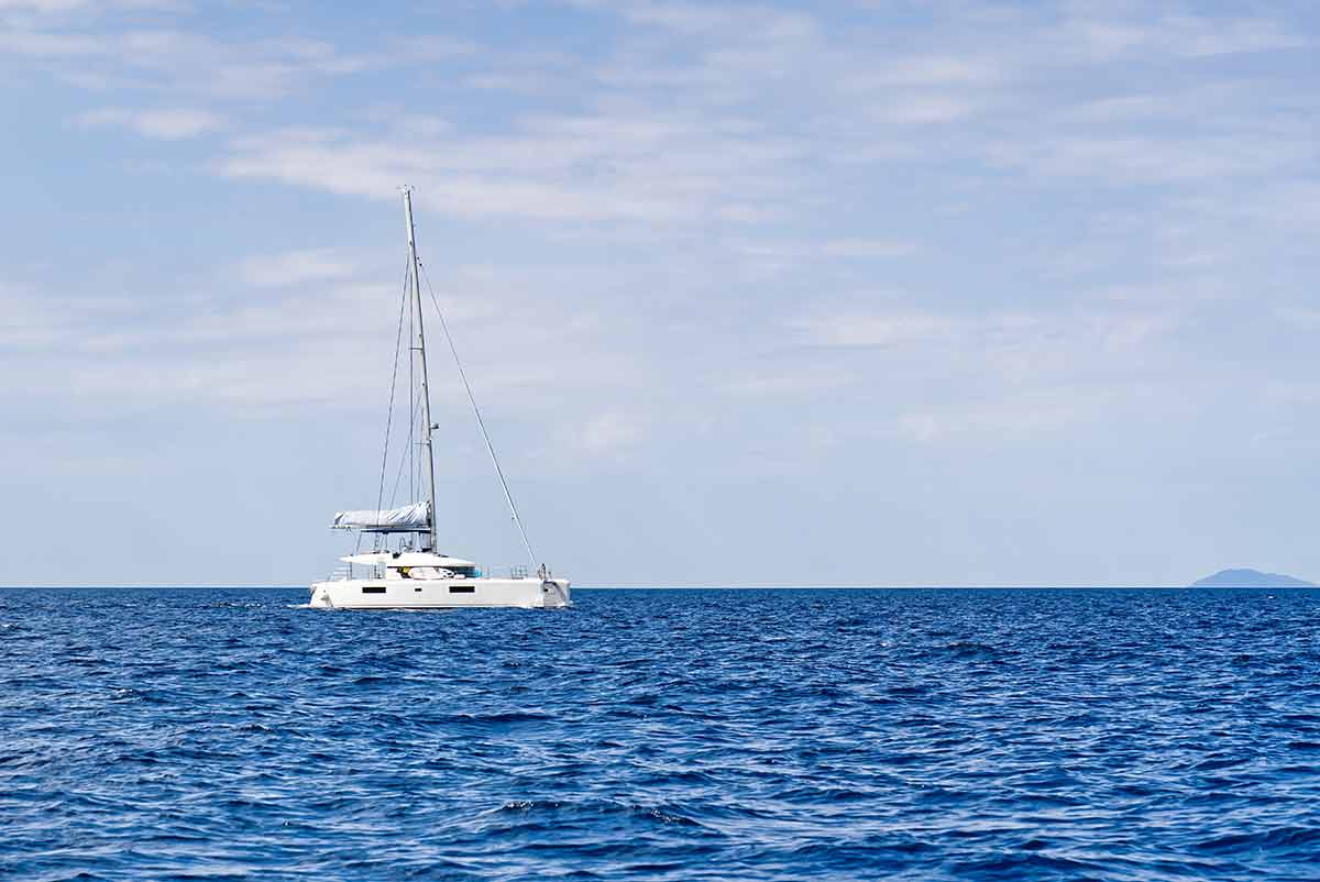 Yacht Catamaran On The Sea. Catamaran Sailing On Turquoise Waters.