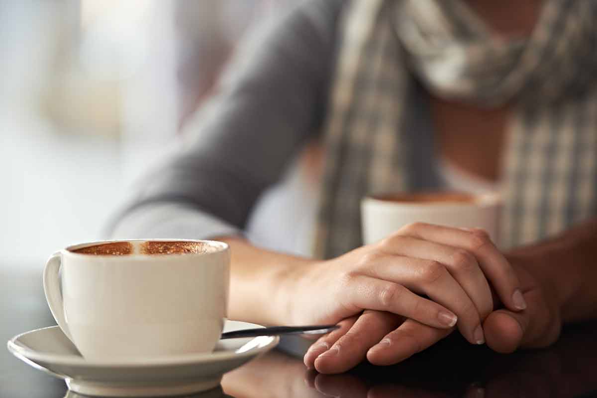 woman blurred in the background and cup of coffee