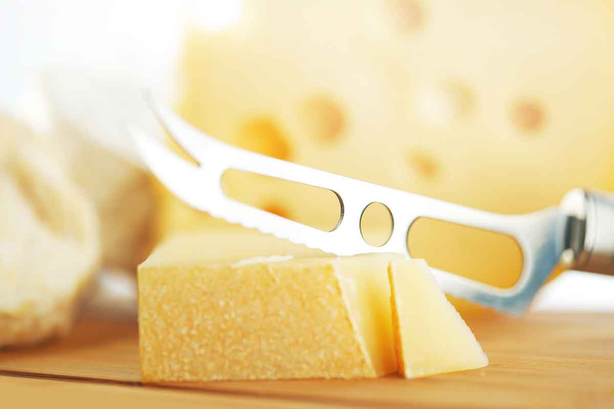 knife cutting into cheese