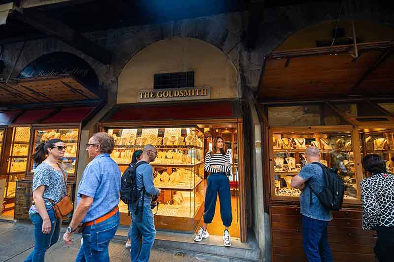 Jewelry Store Clerk And Tourists On The Ponte Vecchio Bridge