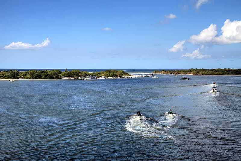 fun things to do in fort myers Boats sail through New Pass of Estero Bay toward the ocean