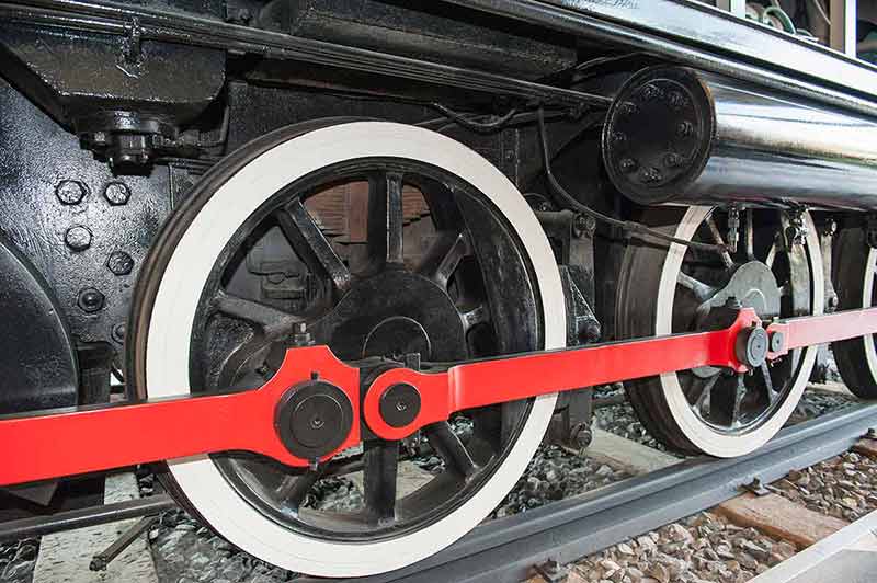 fun things to do in huntsville alabama closeup detail of wheels on old railway engine.