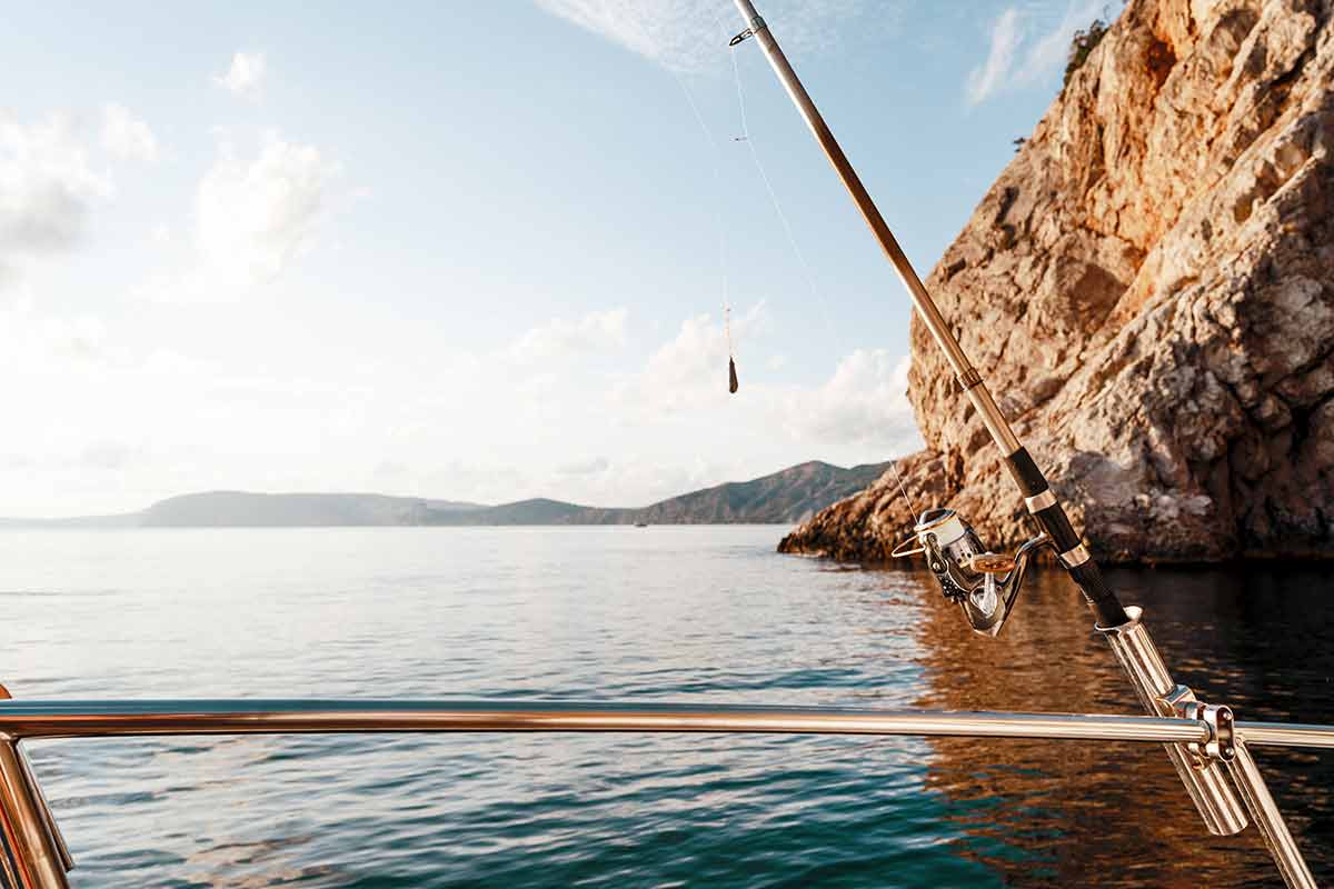 fun things to do in ixtapa mexico Fishing rod on a sailboat on the background of the open sea