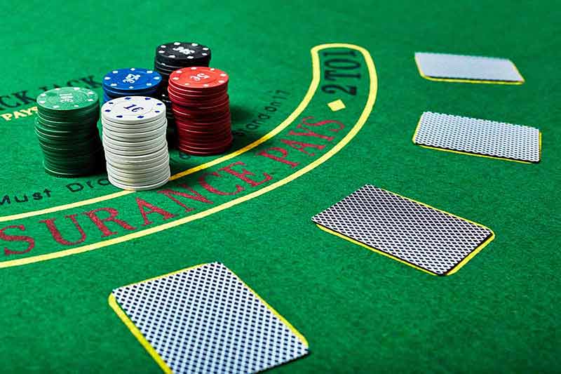 fun things to do in long beach Casino chips and cards on casino table, poker game concept