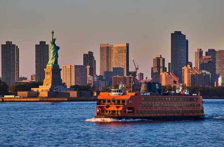 20 Best Things To Do In Staten Island Large Staten Island Ferry Passing By Statue of Liberty In Golden Hour