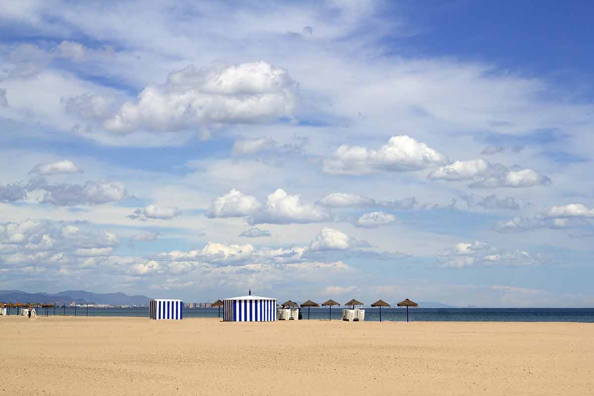 the beach, blue sky and beach huts