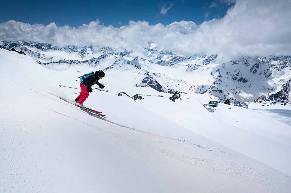 Woman Skier Skiing, Downhill In High Mountains